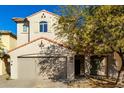 Two-story house with tan exterior, and a two-car garage at 9442 W Palm Ln, Phoenix, AZ 85037