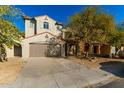 Two-story house with tan exterior, and a two-car garage at 9442 W Palm Ln, Phoenix, AZ 85037