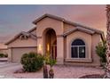 House with a two-car garage and desert landscaping at 11623 W Lemon Ct, Surprise, AZ 85378