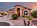 Single-story home with arched entryway and neutral colors at 11623 W Lemon Ct, Surprise, AZ 85378