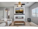 Living room features a modern fireplace and large TV at 13257 W Avenida Del Rey Dr, Peoria, AZ 85383