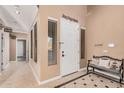 Bright entryway with tiled floor, bench, and access to guest rooms at 18147 W Desert View Ln, Goodyear, AZ 85338