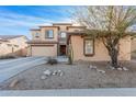 Two-story house with desert landscaping, two-car garage, and neutral color palette at 18147 W Desert View Ln, Goodyear, AZ 85338