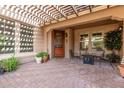 Covered patio with seating area, fire pit, and access to the front door at 4939 W Jomax Rd, Phoenix, AZ 85083