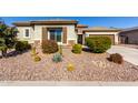 House exterior showcasing desert landscaping and a two-car garage at 5640 W Victory Way, Florence, AZ 85132