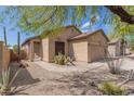 Tan house with a two-car garage and desert landscaping at 6416 E Hacienda La Noria Ln, Gold Canyon, AZ 85118