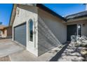 Newly painted home with gray front door and garage at 6934 W Mclellan Rd, Glendale, AZ 85303