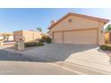 House exterior with driveway and landscaping at 10417 E Champagne Dr, Sun Lakes, AZ 85248