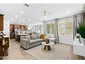 Open living room and kitchen with grey sectional sofa at 17755 W Jojoba Rd, Goodyear, AZ 85338