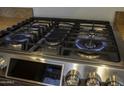 Close-up view of a gas cooktop with five burners at 20948 N Sansom Dr, Maricopa, AZ 85138