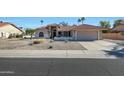 Single-story home with tile roof and a well-manicured front yard at 21019 N Desert Sands Dr, Sun City West, AZ 85375