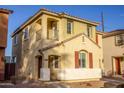 Two-story house with tan exterior, red shutters, and a balcony at 2208 N 78Th Gln, Phoenix, AZ 85035