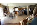 Open-concept kitchen featuring a central island with bar seating and tile flooring at 24848 N Good Pasture Ln, Florence, AZ 85132