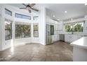 Bright kitchen with white cabinets, stainless steel appliances, and tile flooring at 3871 W Jasper Dr, Chandler, AZ 85226