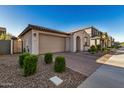 Two-car garage with a landscaped front yard and neutral color scheme at 9317 E Static Ave, Mesa, AZ 85212
