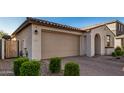New construction home with a modern exterior and a two-car garage at 9317 E Static Ave, Mesa, AZ 85212