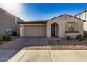 New construction home with a modern exterior and a two-car garage at 9317 E Static Ave, Mesa, AZ 85212