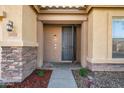 Inviting front door entrance with stone accents and landscaping at 9931 W Odeum Ln, Tolleson, AZ 85353