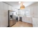 Modern white kitchen with stainless steel appliances at 1132 W 21St Ave, Apache Junction, AZ 85120