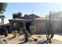 Southwestern-style home with desert landscaping, neutral color palette, and attached garage at 1133 E Dust Devil Dr, San Tan Valley, AZ 85143