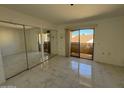 Main bedroom with mirrored closet and access to balcony at 12221 W Bell Rd # 363, Surprise, AZ 85378