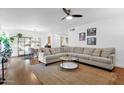 Living room features L-shaped sofa, hardwood floors, and decorative shelving at 1241 E Medlock Dr # 110, Phoenix, AZ 85014