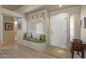 Bright entryway with built-in window seat and hardwood floors at 15220 W Blue Verde Dr, Sun City West, AZ 85375