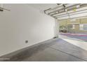 Bright and clean garage with open door showing the exterior at 15240 N 142Nd Ave # 2159, Surprise, AZ 85379