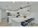 Modern kitchen with white cabinets and island at 1671 E Dogwood Ln, Gilbert, AZ 85295