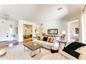 Spacious living room featuring comfortable seating and a large area rug at 18187 W Wind Song Ave, Goodyear, AZ 85338