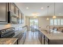 Kitchen boasts granite countertops and stainless steel appliances at 18439 W Wind Song Ave, Goodyear, AZ 85338