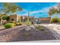 Desert landscape surrounds this beautiful home with stucco exterior, and a large garage at 19007 E Lazo Ct, Rio Verde, AZ 85263