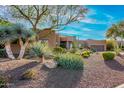 Desert landscape surrounds this beautiful home with stucco exterior, and a large garage at 19007 E Lazo Ct, Rio Verde, AZ 85263