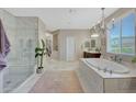 Elegant bathroom with a soaking tub, glass shower, and marble at 20744 W Hamilton St, Buckeye, AZ 85396