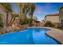 Inviting freeform swimming pool with a waterfall feature at 20744 W Hamilton St, Buckeye, AZ 85396