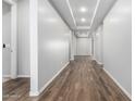 Bright hallway with wood-look tile flooring and neutral walls at 21160 E Cattle Dr, Queen Creek, AZ 85142