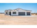 Charming single-story home with a three-car garage, desert landscaping, and a neutral color palette at 25505 W Brookhart Way, Wittmann, AZ 85361