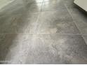 Close-up view of newly installed gray tiled flooring in the home's interior at 25505 W Brookhart Way, Wittmann, AZ 85361