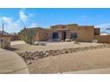 Tan stucco house with a rock and gravel front yard at 2731 E Laurel Ln, Phoenix, AZ 85028