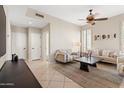 Bright living room boasts neutral walls, a modern ceiling fan, tile flooring, and stylish furniture at 2742 N Augustine --, Mesa, AZ 85207