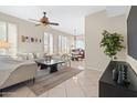 Spacious living room with neutral decor, view into kitchen, ceiling fan, and cozy furniture at 2742 N Augustine --, Mesa, AZ 85207