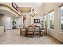 Bright dining area with a large glass-top table and chandelier at 28990 N White Feather Ln # 130, Scottsdale, AZ 85262