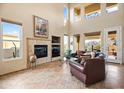 Relaxing living room with fireplace and large windows at 28990 N White Feather Ln # 130, Scottsdale, AZ 85262