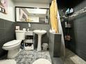 Modern bathroom with gray tile, pedestal sink, and shower at 3125 W Mclellan Blvd, Phoenix, AZ 85017