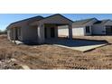 Newly built gray stucco home with attached garage and modern design on a construction site at 3205 W Sueno Dr, Eloy, AZ 85131