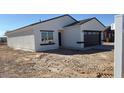 Charming home displays a stucco facade, dark trim and tiled roof, complemented by the new desert landscaping at 3215 W Sueno Dr, Eloy, AZ 85131