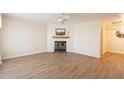 Living room with fireplace and wood flooring at 3249 W Maryland Ave, Phoenix, AZ 85017