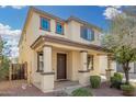 Inviting two-story home with a covered porch, attractive landscaping, and great curb appeal at 3451 E Tyson St, Gilbert, AZ 85295