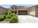 Two-story home with a two-car garage and manicured landscaping at 3554 N Hooper St, Buckeye, AZ 85396