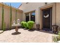 Inviting front patio with decorative landscaping and wrought-iron door at 3554 N Hooper St, Buckeye, AZ 85396